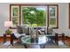 Cozy sitting area featuring bench seating with large window to wooded front yard at 4703 Pleasant Green Rd, Durham, NC 27705