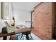 Inviting home office with brick wall, tile floor, desk and natural light at 4703 Pleasant Green Rd, Durham, NC 27705