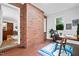 Cozy office with red brick wall, tile floor, a desk, and natural light at 4703 Pleasant Green Rd, Durham, NC 27705