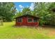 Exterior view of a red outbuilding with a gable roof and three windows at 4703 Pleasant Green Rd, Durham, NC 27705