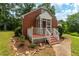 Charming home showcasing a cozy screened porch, inviting front yard, and brick exterior at 4703 Pleasant Green Rd, Durham, NC 27705
