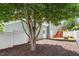 View of an outdoor space with a tree and a white fence in the background at 500 Weaver Mine Trl, Chapel Hill, NC 27517