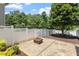 Backyard featuring a fire pit, white fence, and stone landscaping at 500 Weaver Mine Trl, Chapel Hill, NC 27517