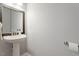 Simple powder room with pedestal sink, framed mirror, and neutral wall color at 500 Weaver Mine Trl, Chapel Hill, NC 27517