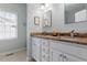 Bathroom featuring double sink vanity, natural stone countertop, and neutral decor at 500 Weaver Mine Trl, Chapel Hill, NC 27517