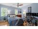 Bright bedroom with a ceiling fan, two windows, a work desk, and neutral-colored walls at 500 Weaver Mine Trl, Chapel Hill, NC 27517