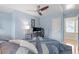 Comfortable bedroom with blue walls, a ceiling fan, a work desk, and plenty of natural light at 500 Weaver Mine Trl, Chapel Hill, NC 27517