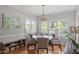 Bright dining area featuring a chandelier, large windows and stylish decor at 500 Weaver Mine Trl, Chapel Hill, NC 27517