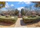Beautiful brick fountain surrounded by manicured hedges in a neighborhood courtyard on a sunny day at 500 Weaver Mine Trl, Chapel Hill, NC 27517