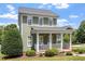 Charming two-story home with a welcoming front porch, manicured landscaping, and a well-maintained lawn at 500 Weaver Mine Trl, Chapel Hill, NC 27517