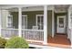 View of cozy front porch with rocking chairs and wooden floors at 500 Weaver Mine Trl, Chapel Hill, NC 27517