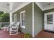 Charming porch featuring rocking chairs, wood decking and a classic entrance at 500 Weaver Mine Trl, Chapel Hill, NC 27517