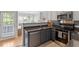 Bright kitchen showcasing stainless steel appliances, stone countertops, and a view to the Gathering room at 500 Weaver Mine Trl, Chapel Hill, NC 27517
