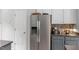Kitchen featuring stainless steel refrigerator and dark countertops with white upper cabinets at 500 Weaver Mine Trl, Chapel Hill, NC 27517