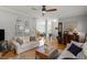 Open-concept living room with hardwood floors, comfortable seating, and stylish decor at 500 Weaver Mine Trl, Chapel Hill, NC 27517