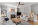 Inviting living room featuring a cozy fireplace, ceiling fan, and comfortable seating at 500 Weaver Mine Trl, Chapel Hill, NC 27517
