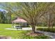Outdoor area showcasing a gazebo and green space with trees in the distance at 500 Weaver Mine Trl, Chapel Hill, NC 27517