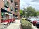 Outdoor dining area with red chairs in front of a local restaurant at 500 Weaver Mine Trl, Chapel Hill, NC 27517