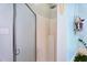 Bright bathroom features a glass enclosed shower and a macrame wall hanging at 5405 Doemont Dr, Apex, NC 27539