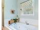 Jetted tub features a macrame shade in a well-lit bathroom at 5405 Doemont Dr, Apex, NC 27539