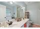 Well-lit bathroom features double sinks, modern fixtures, a jetted tub, and decorative shelving at 5405 Doemont Dr, Apex, NC 27539