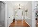 Bright entryway with hardwood floors, white walls, and a front door with sidelights at 5405 Doemont Dr, Apex, NC 27539