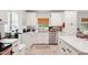 Bright kitchen featuring white cabinets, stainless steel appliances, and ample counter space at 5405 Doemont Dr, Apex, NC 27539
