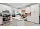 Well-lit kitchen with white cabinets, an island, stainless steel appliances and natural light at 5405 Doemont Dr, Apex, NC 27539