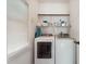 Functional laundry area with modern washer and dryer units, and storage shelves at 5405 Doemont Dr, Apex, NC 27539