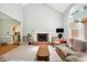 Comfortable living room featuring a fireplace, vaulted ceilings, and neutral colors at 5405 Doemont Dr, Apex, NC 27539