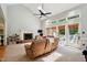 Cozy living room featuring high ceilings, a fireplace, and sliding doors leading to the deck at 5405 Doemont Dr, Apex, NC 27539