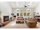 Bright living room with a vaulted ceiling, brick fireplace, and comfortable seating at 5405 Doemont Dr, Apex, NC 27539