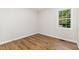 Bedroom with a large window letting in lots of natural light and wood flooring at 5428 Passenger Pl, Raleigh, NC 27603