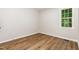 Bedroom with a large window letting in lots of natural light and wood flooring at 5428 Passenger Pl, Raleigh, NC 27603