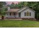 Charming single-story home features a cozy front porch and well-maintained landscaping at 5428 Passenger Pl, Raleigh, NC 27603