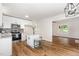 Open concept floor plan kitchen with stainless appliances, an island with seating, and modern fixtures at 5428 Passenger Pl, Raleigh, NC 27603