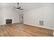 Living room featuring a modern ceiling fan, hardwood floors, and a cozy fireplace at 5428 Passenger Pl, Raleigh, NC 27603