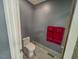 View of the toilet and a towel rack with red towels in the bathroom at 5500 Fortunes Ridge Dr # 94C, Durham, NC 27713