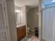 Bathroom featuring granite counters, tile floors, shower and storage at 5500 Fortunes Ridge Dr # 94C, Durham, NC 27713