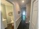 Hallway leading to a half bath featuring stylish gray paint, and tiled floors at 5500 Fortunes Ridge Dr # 94C, Durham, NC 27713