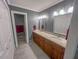 Bathroom showcasing a dual vanity with granite countertop and cabinet storage at 5500 Fortunes Ridge Dr # 94C, Durham, NC 27713