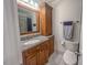 Bathroom featuring vanity with granite countertop, wood cabinets, toilet, and shower at 5500 Fortunes Ridge Dr # 94C, Durham, NC 27713