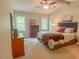 Bright bedroom featuring large windows, ceiling fan, and carpeted floors at 5500 Fortunes Ridge Dr # 94C, Durham, NC 27713