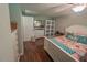 Cozy bedroom with wood floors, white trim, dresser, and storage cabinet at 5500 Fortunes Ridge Dr # 94C, Durham, NC 27713
