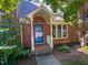 Attractive brick townhome with a charming front porch, complemented by mature trees and manicured shrubbery at 5500 Fortunes Ridge Dr # 94C, Durham, NC 27713