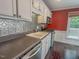 Well-lit kitchen with stainless appliances, dark countertops and backsplash at 5500 Fortunes Ridge Dr # 94C, Durham, NC 27713