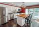Bright kitchen featuring an island with seating, white cabinets, and stainless steel appliances at 5500 Fortunes Ridge Dr # 94C, Durham, NC 27713