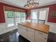 Well lit kitchen featuring an island, white cabinets, and a view to a deck at 5500 Fortunes Ridge Dr # 94C, Durham, NC 27713