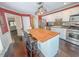 Bright eat-in kitchen featuring a stainless steel oven, and a island with breakfast bar at 5500 Fortunes Ridge Dr # 94C, Durham, NC 27713