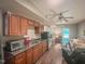 Kitchenette with wood cabinets and stainless steel mini-fridge in living space at 5500 Fortunes Ridge Dr # 94C, Durham, NC 27713